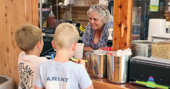 Two young boys buy ice cream from the owner of Sandhills Ice Cream and Treats in Valentine, Nebraska, in May 2023. (Russell Shaffer/Rural Prosperity Nebraska)